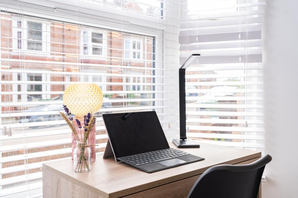 Bright and tidy workspace featuring a modern wo...