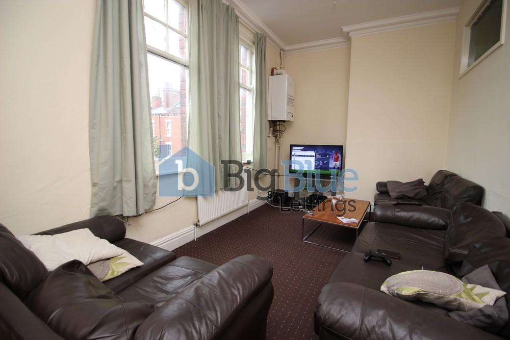 Cozy living room featuring comfortable dark lea...
