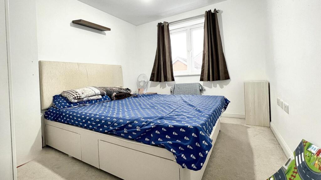 A cozy and bright double bedroom featuring a co...