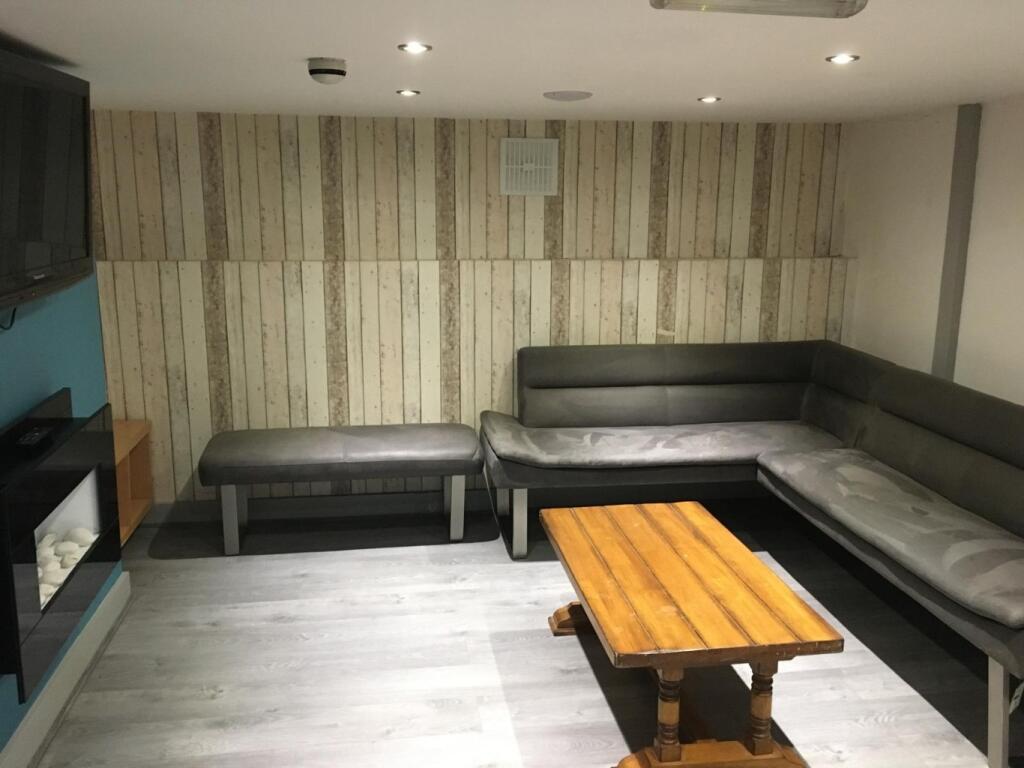 Contemporary lounge with an L-shaped leather so...