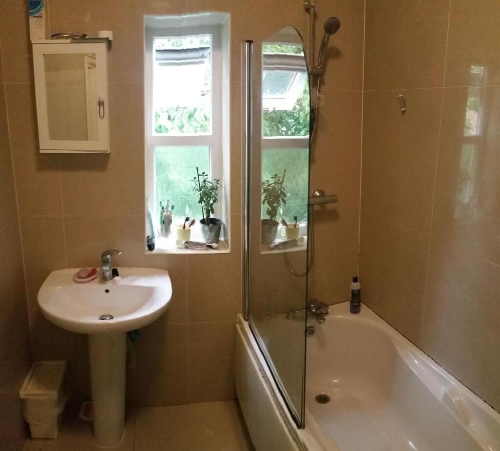 Well-presented bathroom with a large bathtub, p...