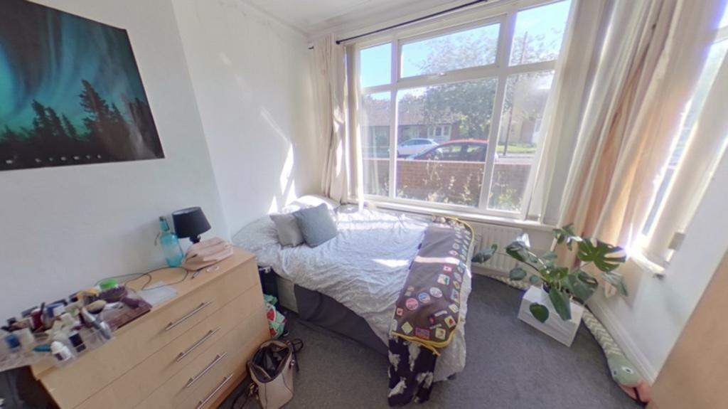 Bright and cozy single bedroom featuring a larg...