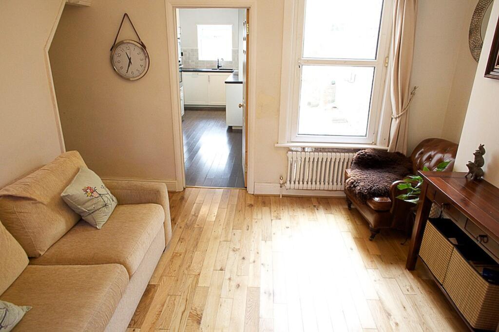 This inviting living room features warm wooden ...