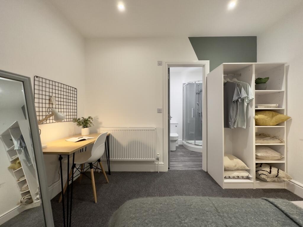 A bright and spacious double bedroom featuring ...