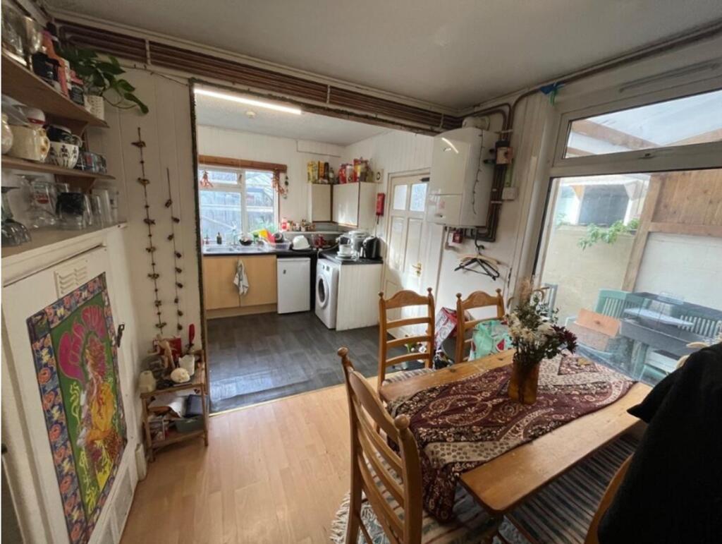 A cozy kitchenette with ample natural light, pe...
