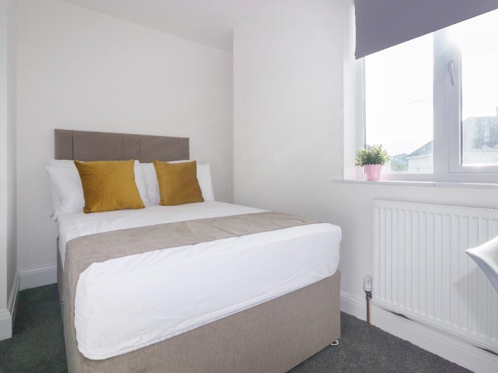 A bright and cozy double bedroom featuring a co...