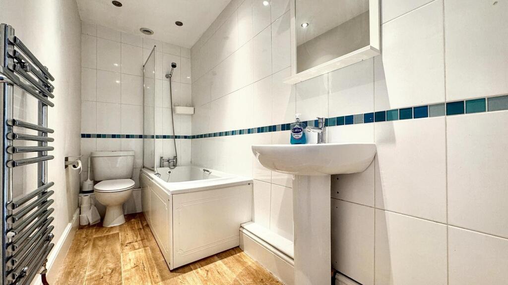 A modern, well-maintained bathroom featuring sl...