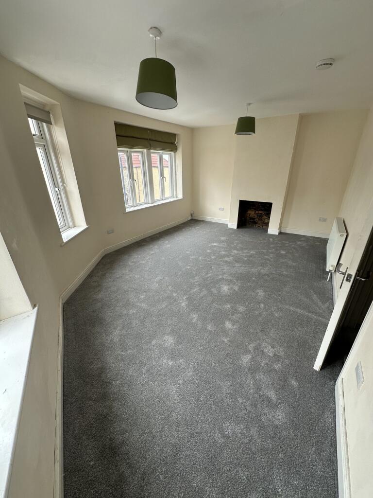 This spacious double bedroom features large win...
