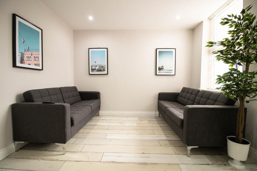A modern and tidy living room featuring two dar...