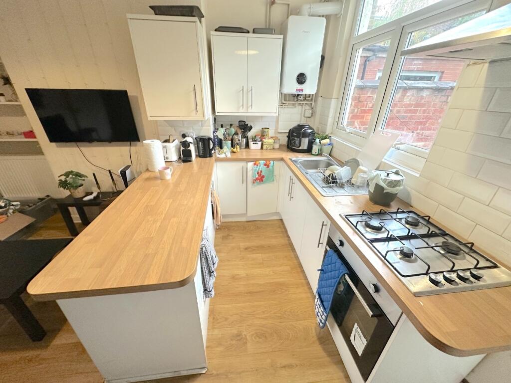 Bright modern kitchen with wooden worktops, int...