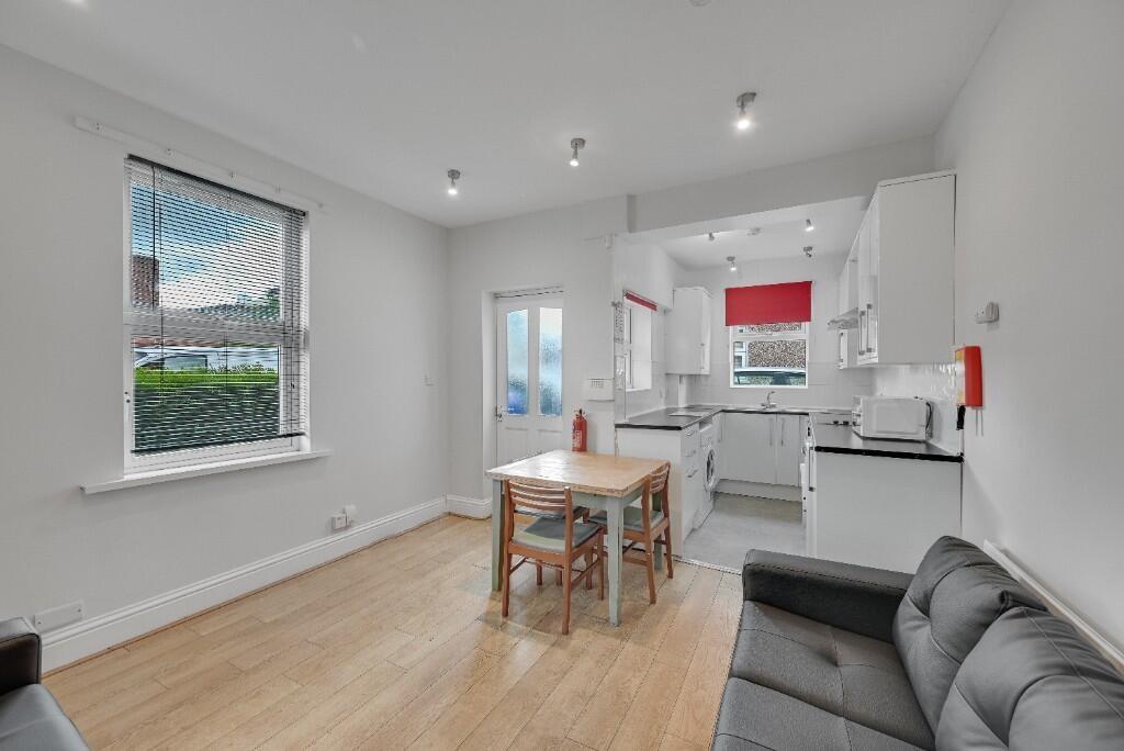 Bright and modern living room with a sleek kitc...