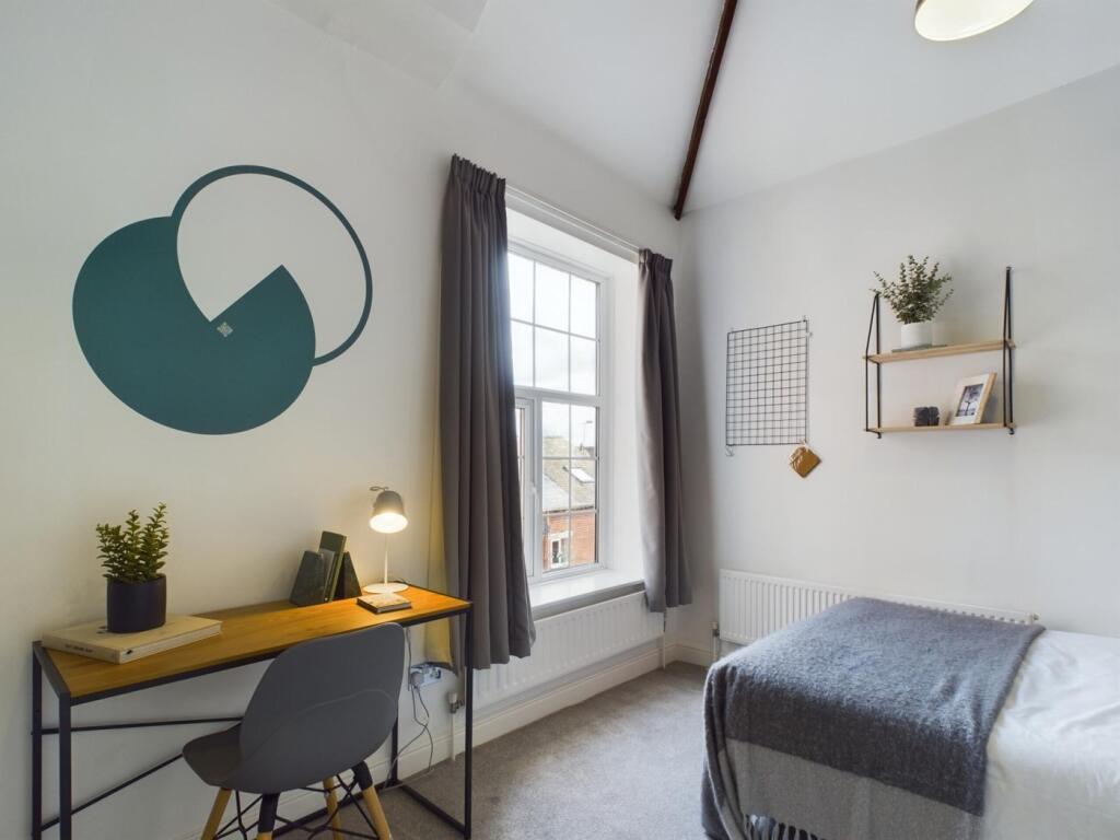 A stylish and well-lit double bedroom featuring...