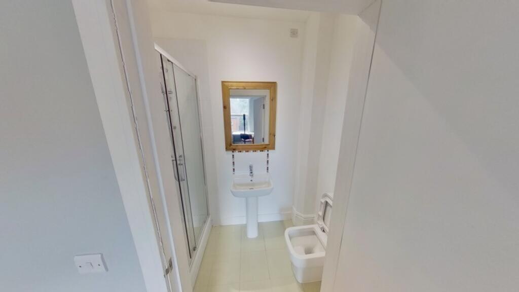 A modern and clean bathroom featuring a shower ...
