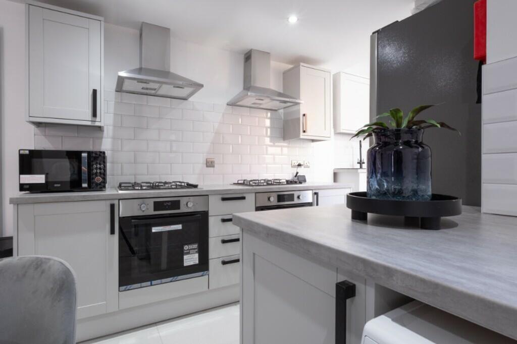 A modern, well-equipped kitchen featuring sleek...