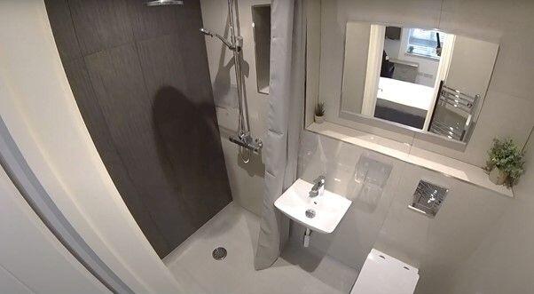Modern compact bathroom with a walk-in shower, ...