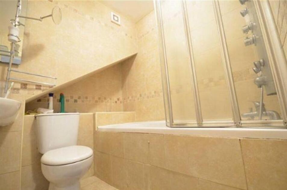 A well-maintained bathroom suite featuring a ba...