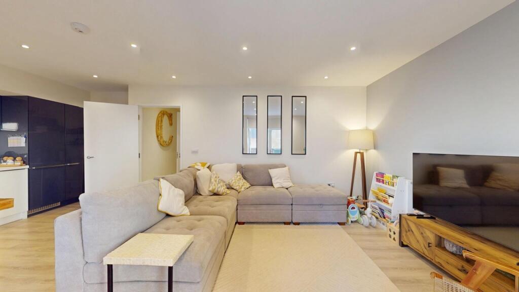 A spacious and modern living room featuring a l...