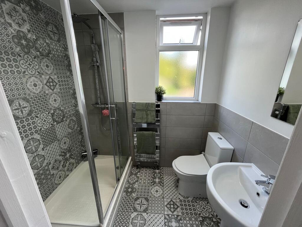 Bright and modern bathroom featuring patterned ...