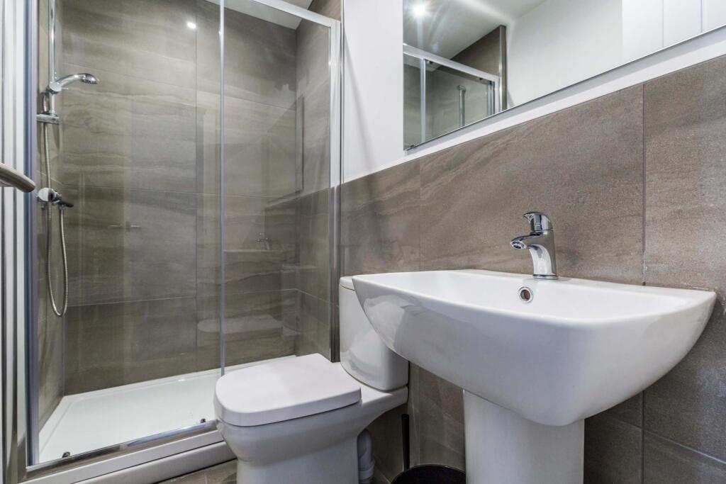 A clean and modern bathroom featuring a large s...