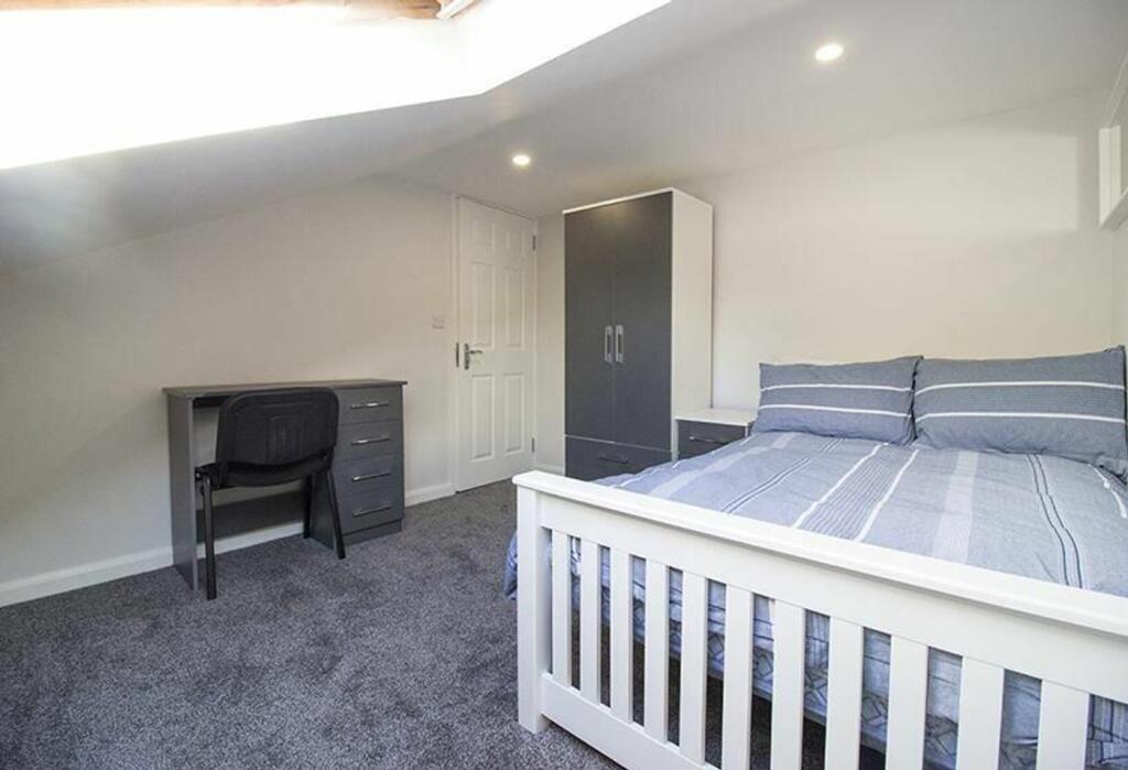 This inviting double bedroom features a comfort...