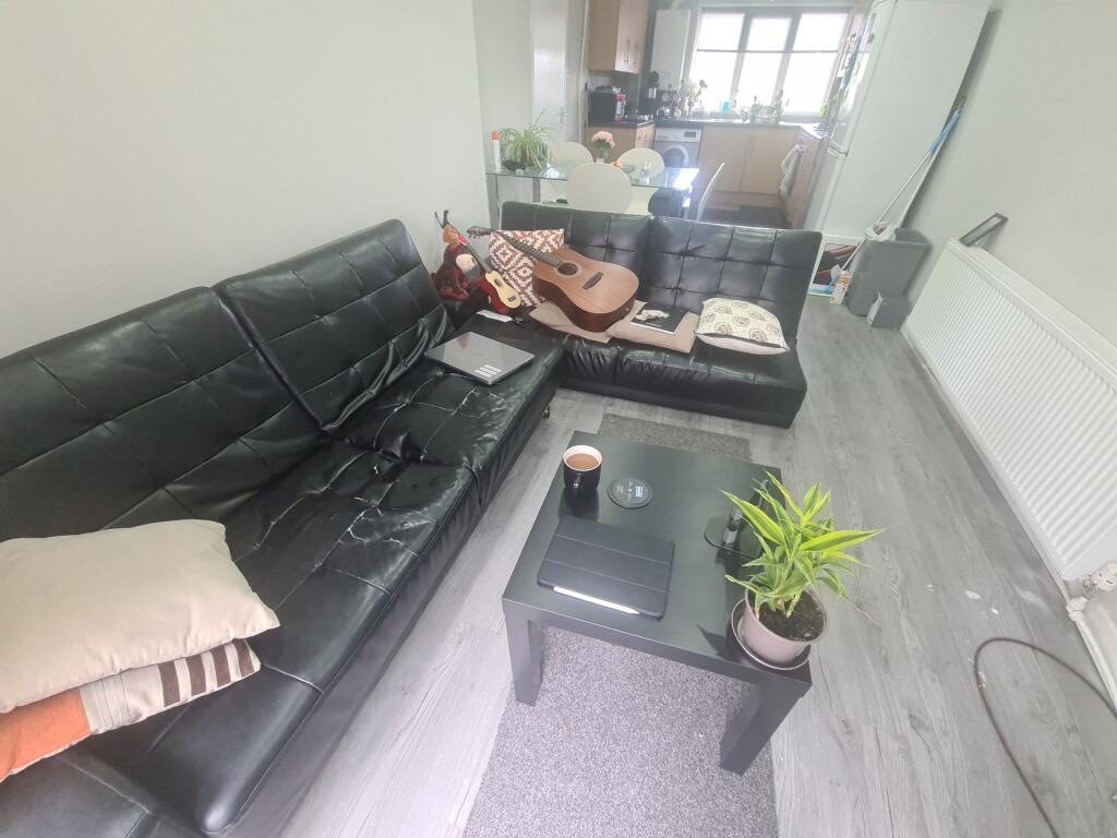 A comfortable living room featuring a large bla...