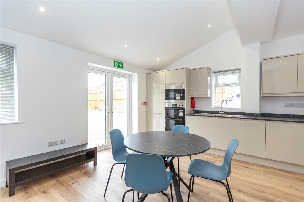 Bright and modern kitchen with ample natural li...