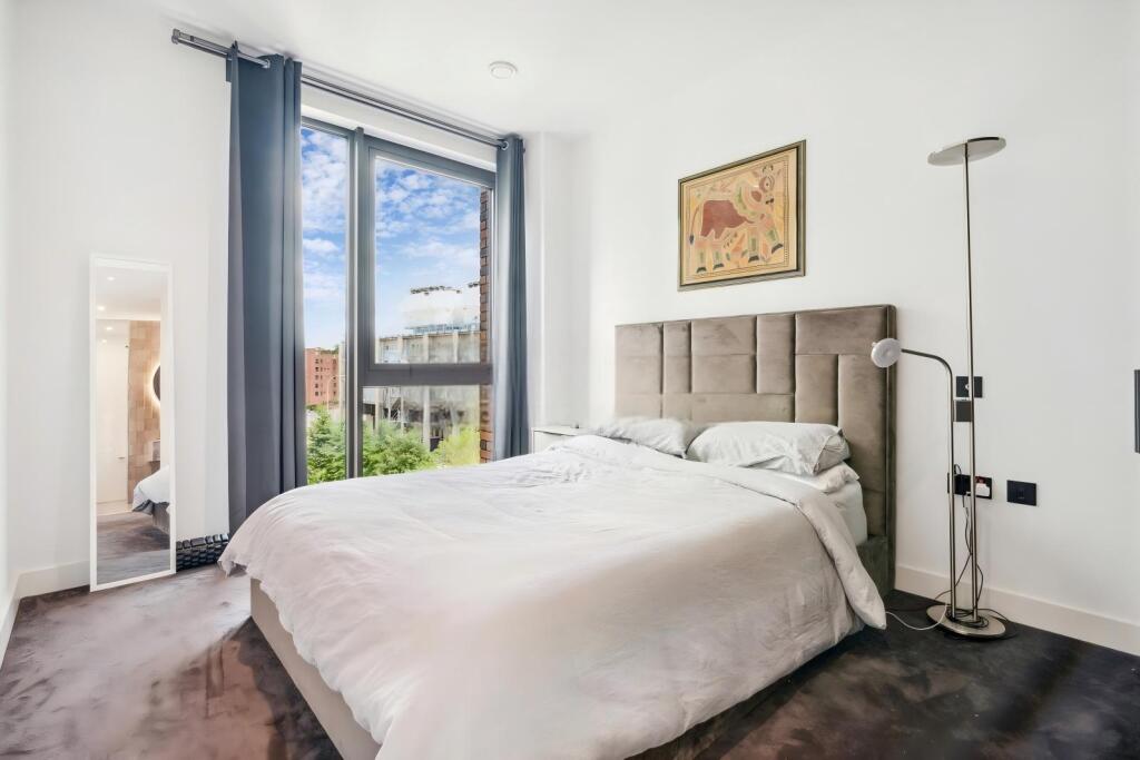 Bright and inviting double bedroom with a large...