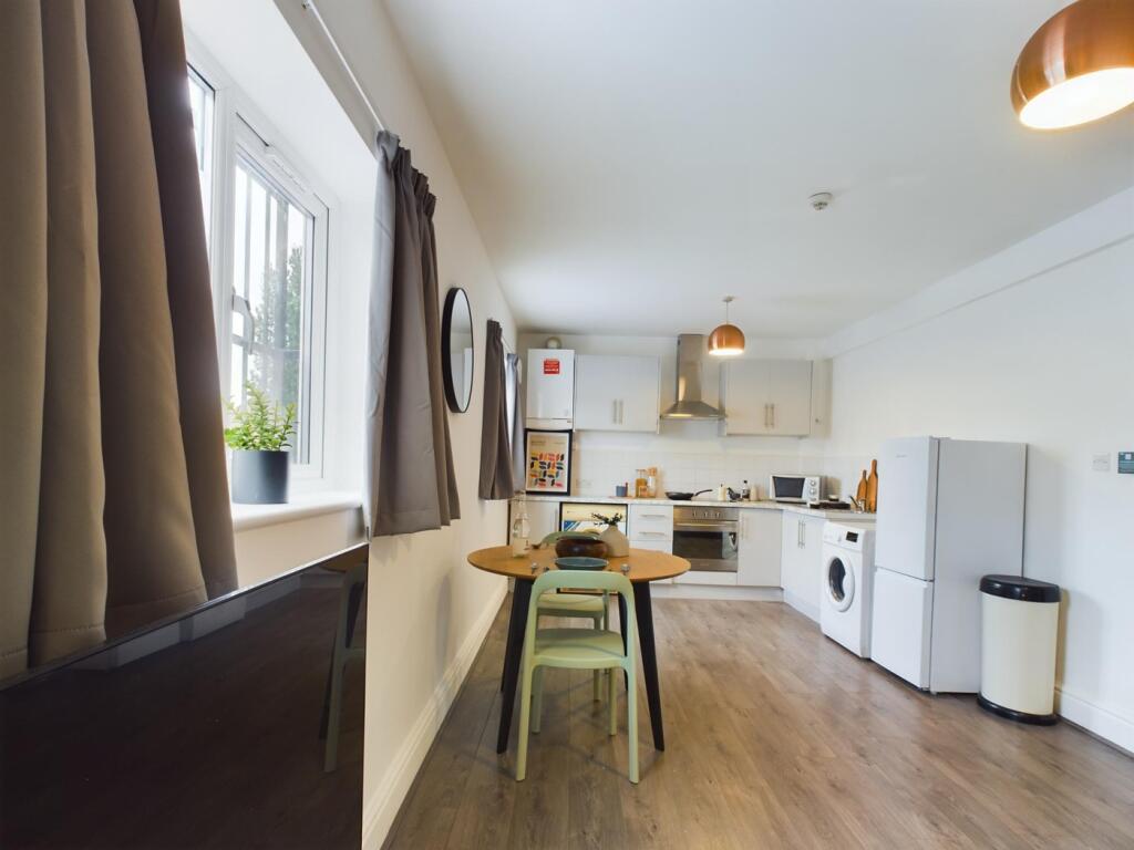A bright and modern kitchenette with ample spac...