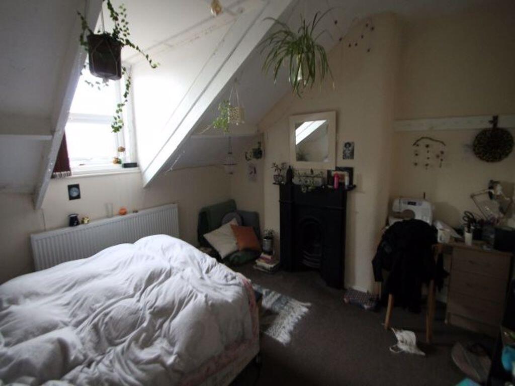 A comfortable master bedroom featuring a large ...