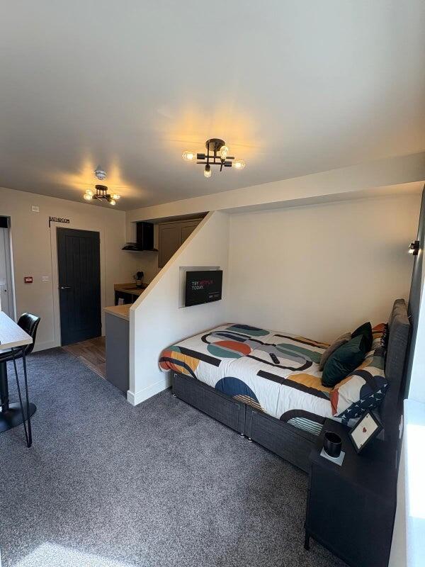 A modern, well-lit double bedroom featuring a c...