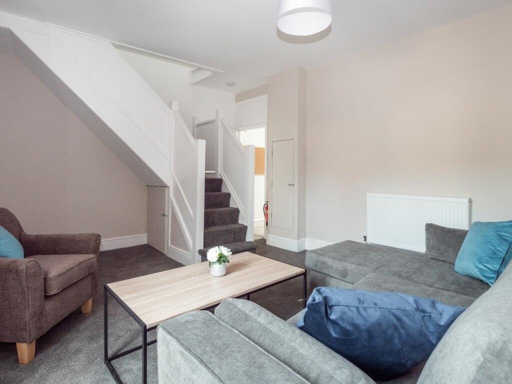 A modern and cozy living room featuring comfort...