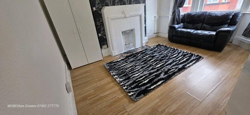 Contemporary living room featuring a stylish bl...