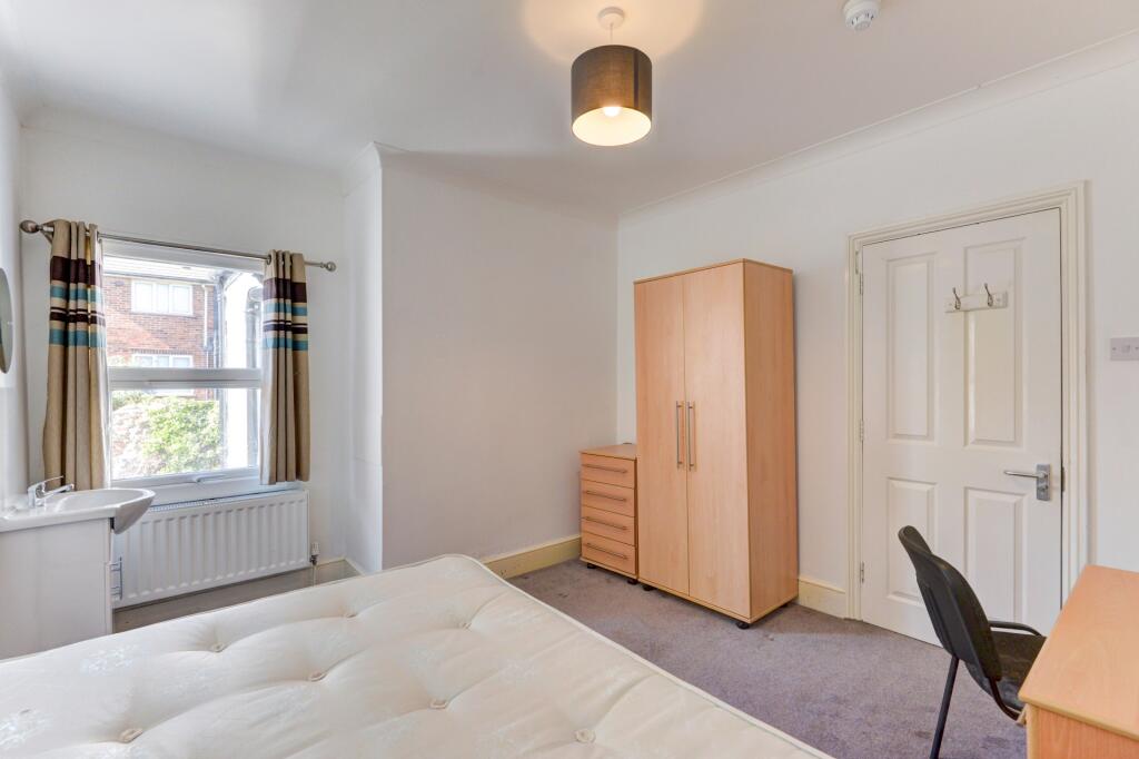 Bright and tidy double bedroom featuring a comf...