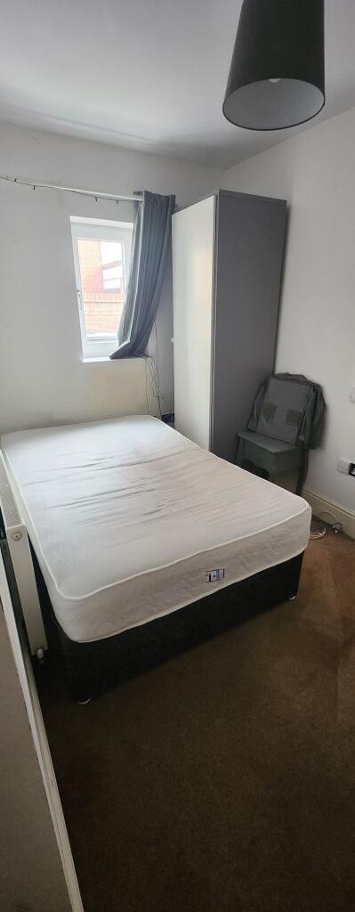 Cozy single bedroom with a comfortable mattress...