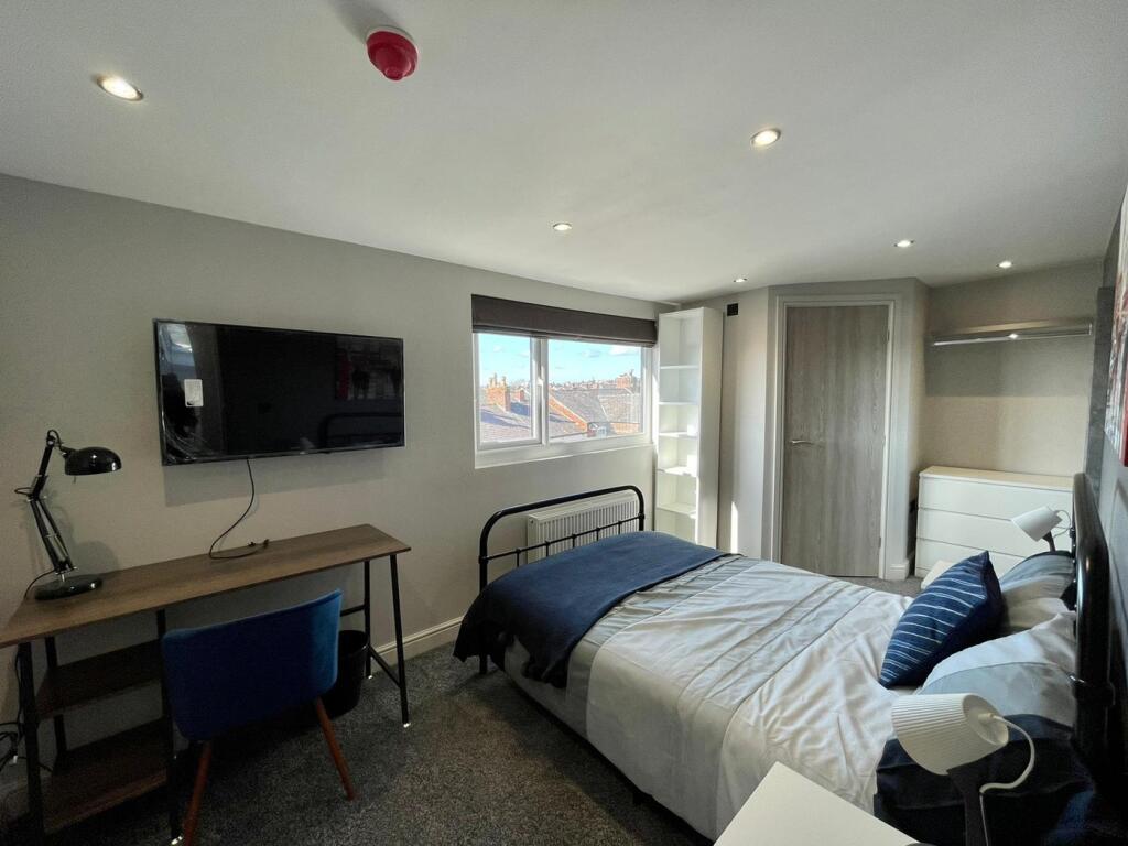 A stylish double bedroom featuring a comfortabl...