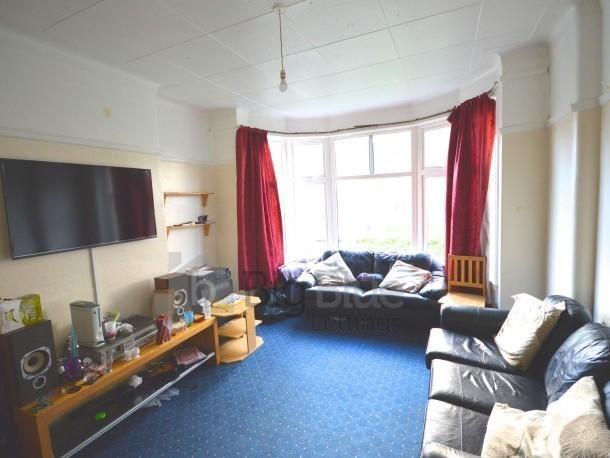 Comfortable living room featuring large bay win...