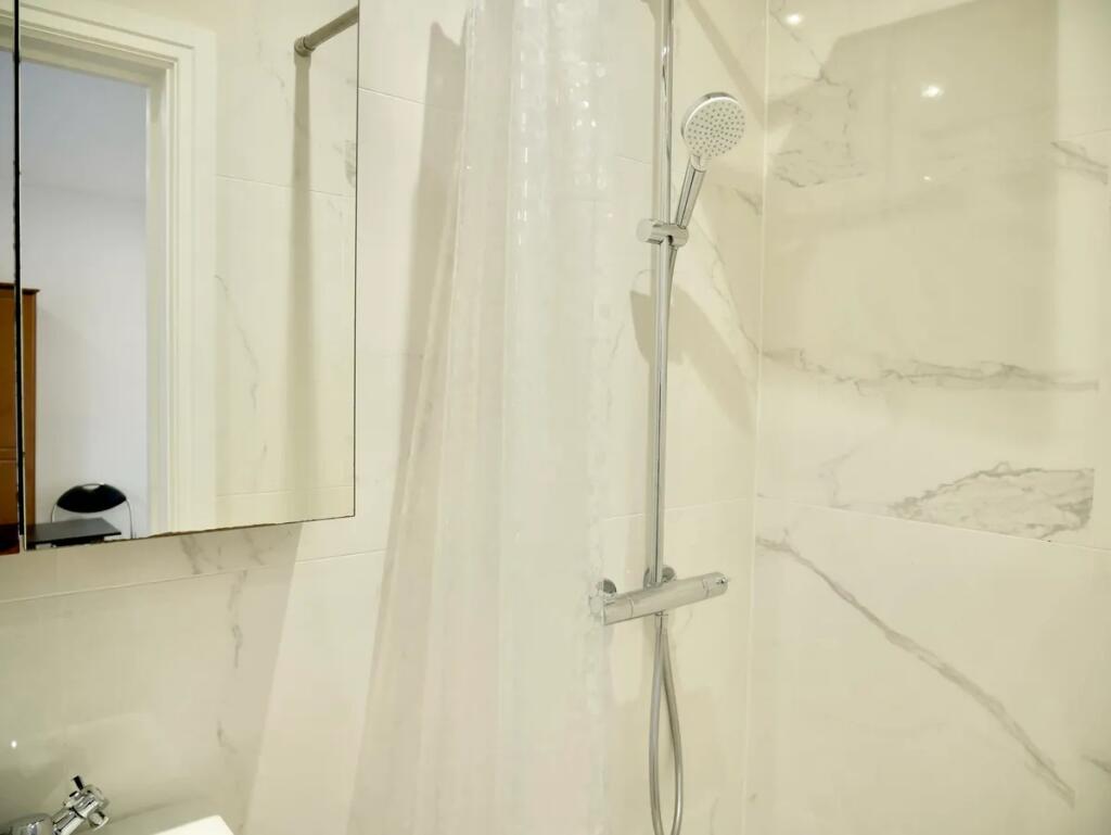 Bright and modern bathroom featuring sleek marb...