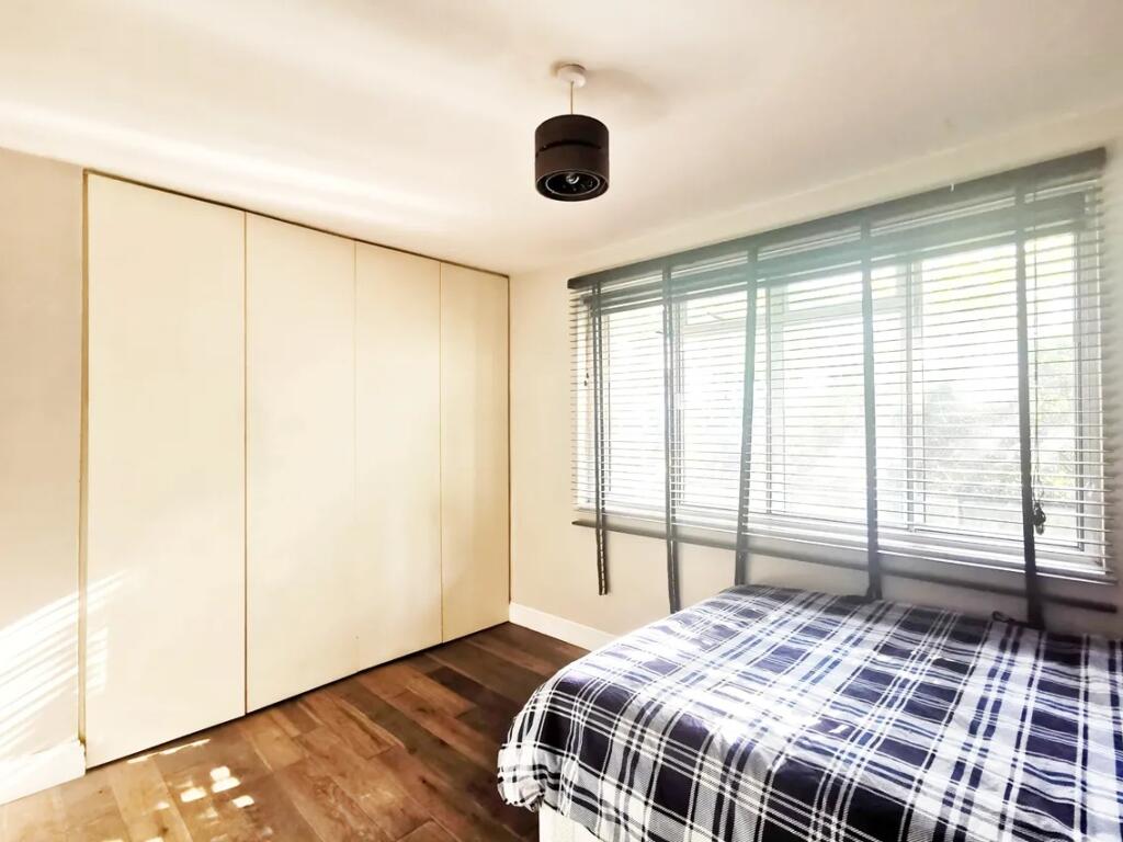 Bright and tidy double bedroom featuring a larg...