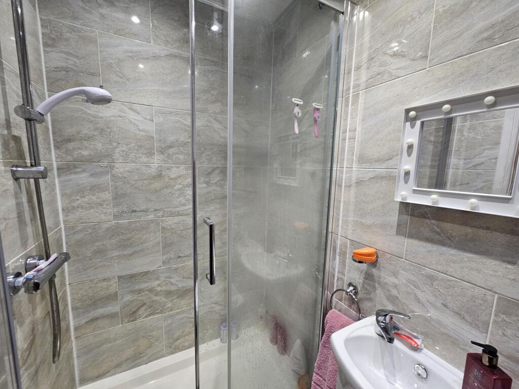 A clean and modern bathroom suite featuring a s...