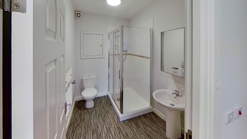 Bright and clean bathroom featuring a modern sh...