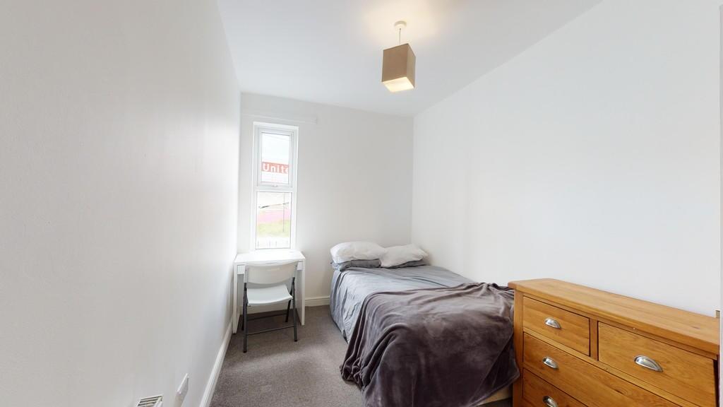 Cozy single bedroom with a comfortable bed, a s...