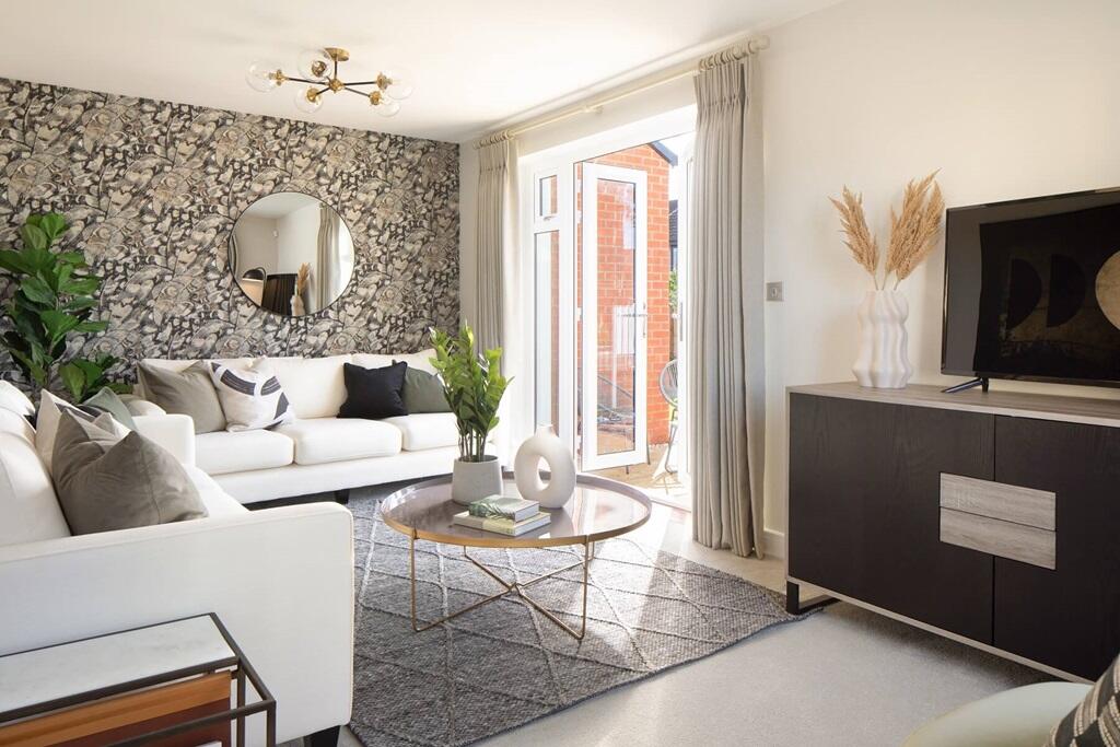 The spacious living room boasts double doors out to the garden