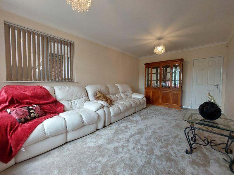 A cozy living room featuring comfortable white ...