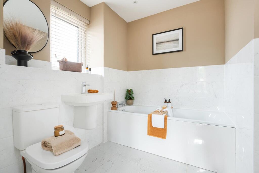 The main bathroom doubles as an ensuite to the main bedroom