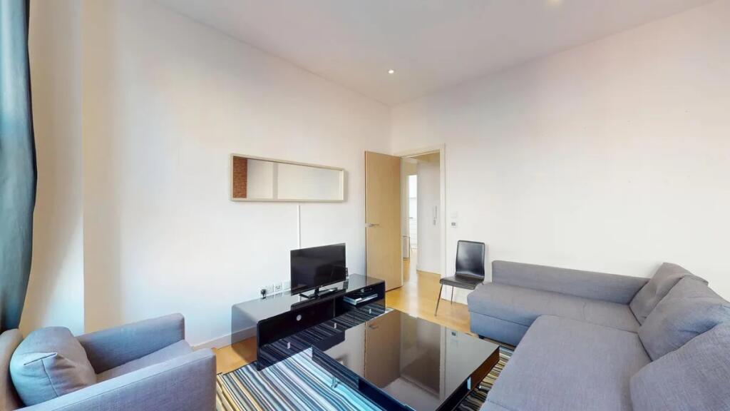 A bright and cozy living room featuring a spaci...