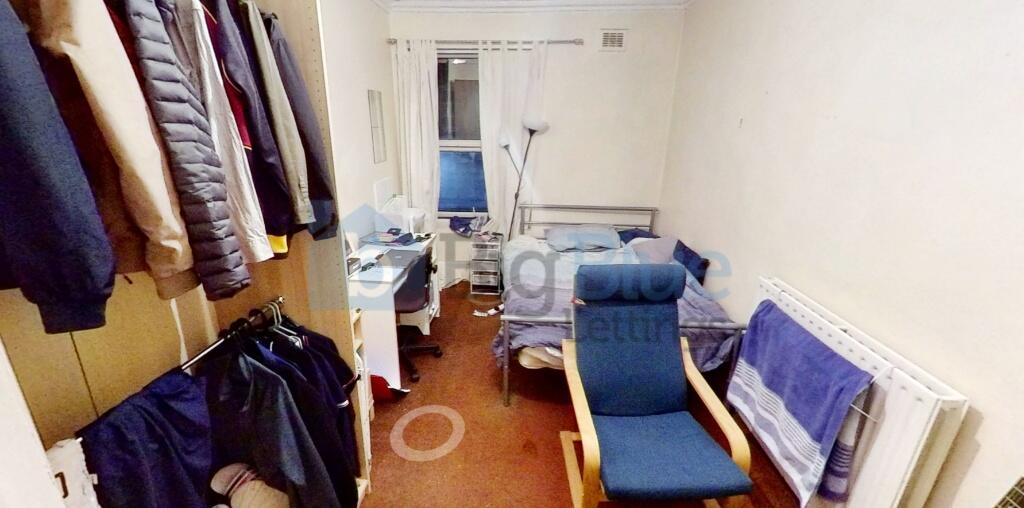 Cozy single bedroom featuring a comfortable rec...