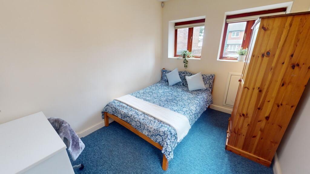 Bright and cozy double bedroom featuring a comf...