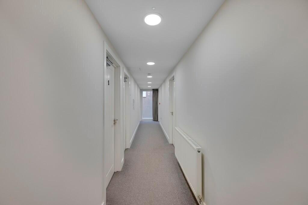 A clean and well-maintained hallway with white ...