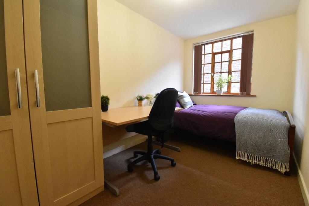 Cozy single bedroom featuring a comfortable sin...