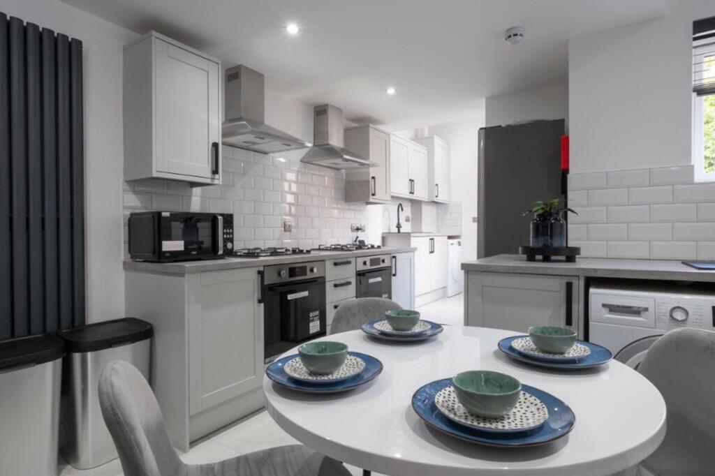 Modern kitchen featuring sleek cabinetry and am...
